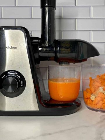 Juicer with Carrot Orange Ginger Juice and pulp.