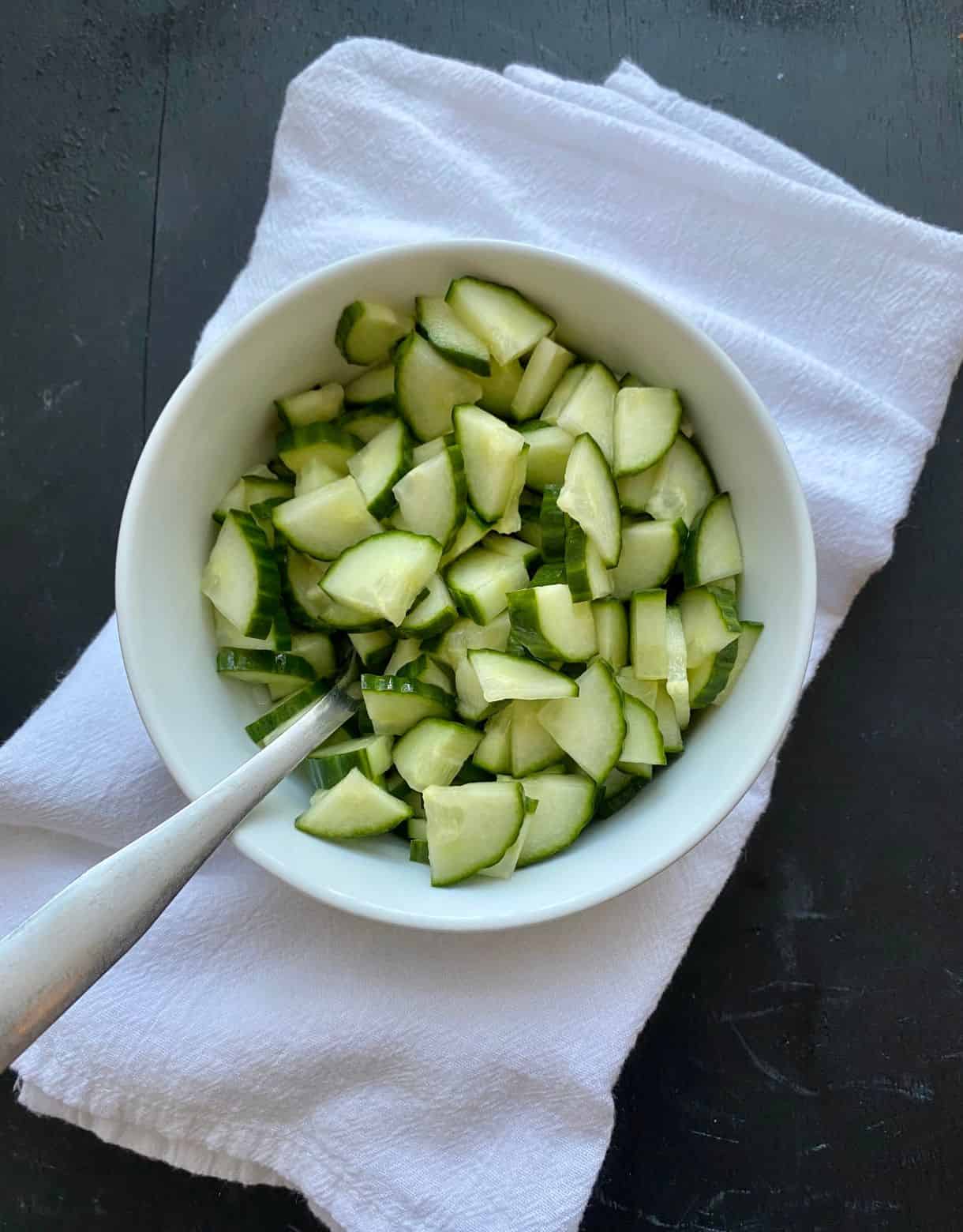 A bowl of pickled cucumbers.