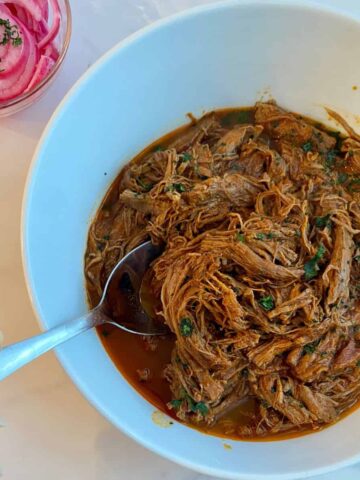 A bowl of Slow Cooker Pulled Beef taco meat.