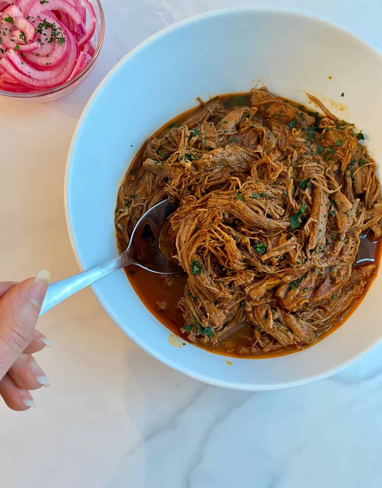 A bowl of Slow Cooker Pulled Beef Taco meat.