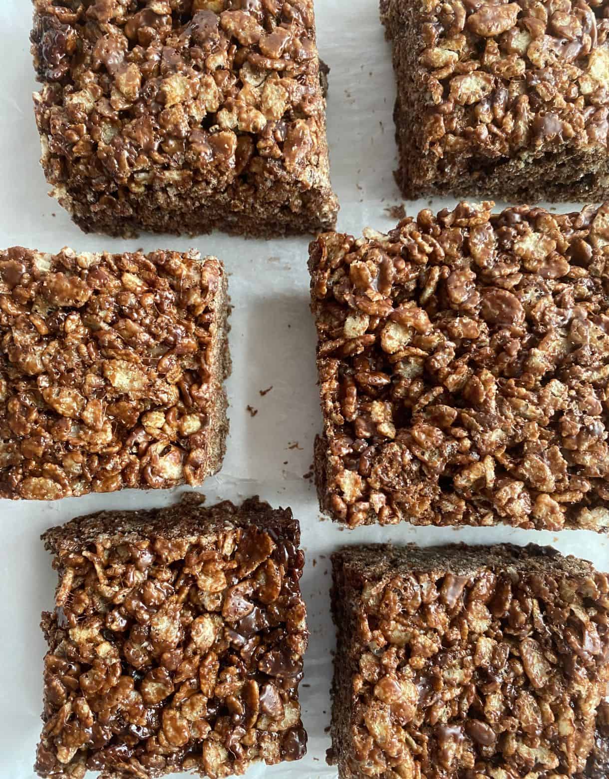 Six Chocoate Rice Krispie Treats cut into squares.