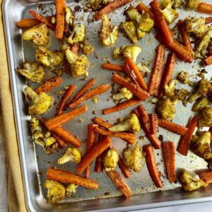 A sheet pan with roasted cauliflower and carrots.