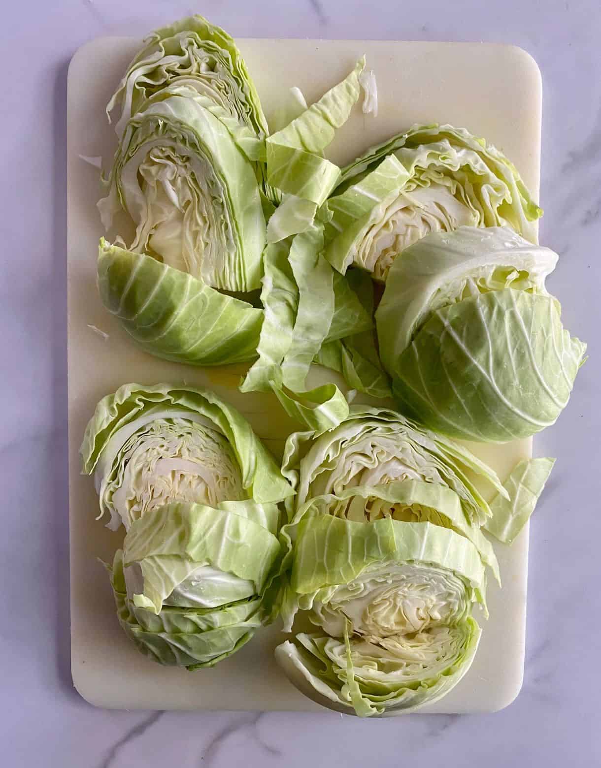 A cutting board with sliced cabbage steaks.