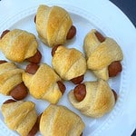 A plate of cooked Little Smokies Pigs in a Blanket with the Healthy Mom Healthy Family logo.