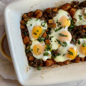 A pan of cooked Sweet Potato Breakfast Hash with sausage, sweet potatoes and eggs.