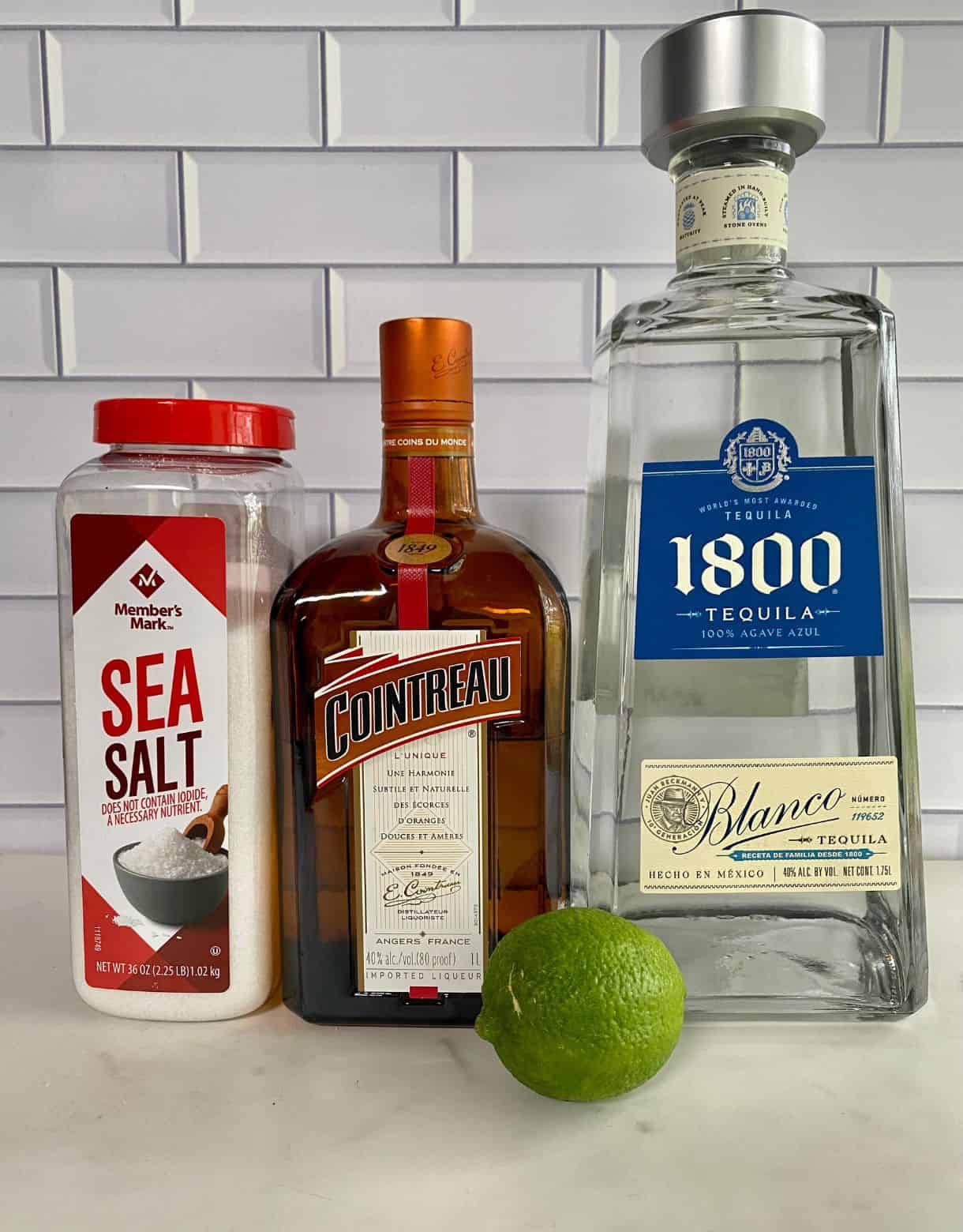 Ingredients for a Cointreau Margarita. Silver tequila, salt, lime and Cointreau.