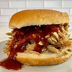 Coca-Cola Pulled Pork on a bun with BBQ sauce.