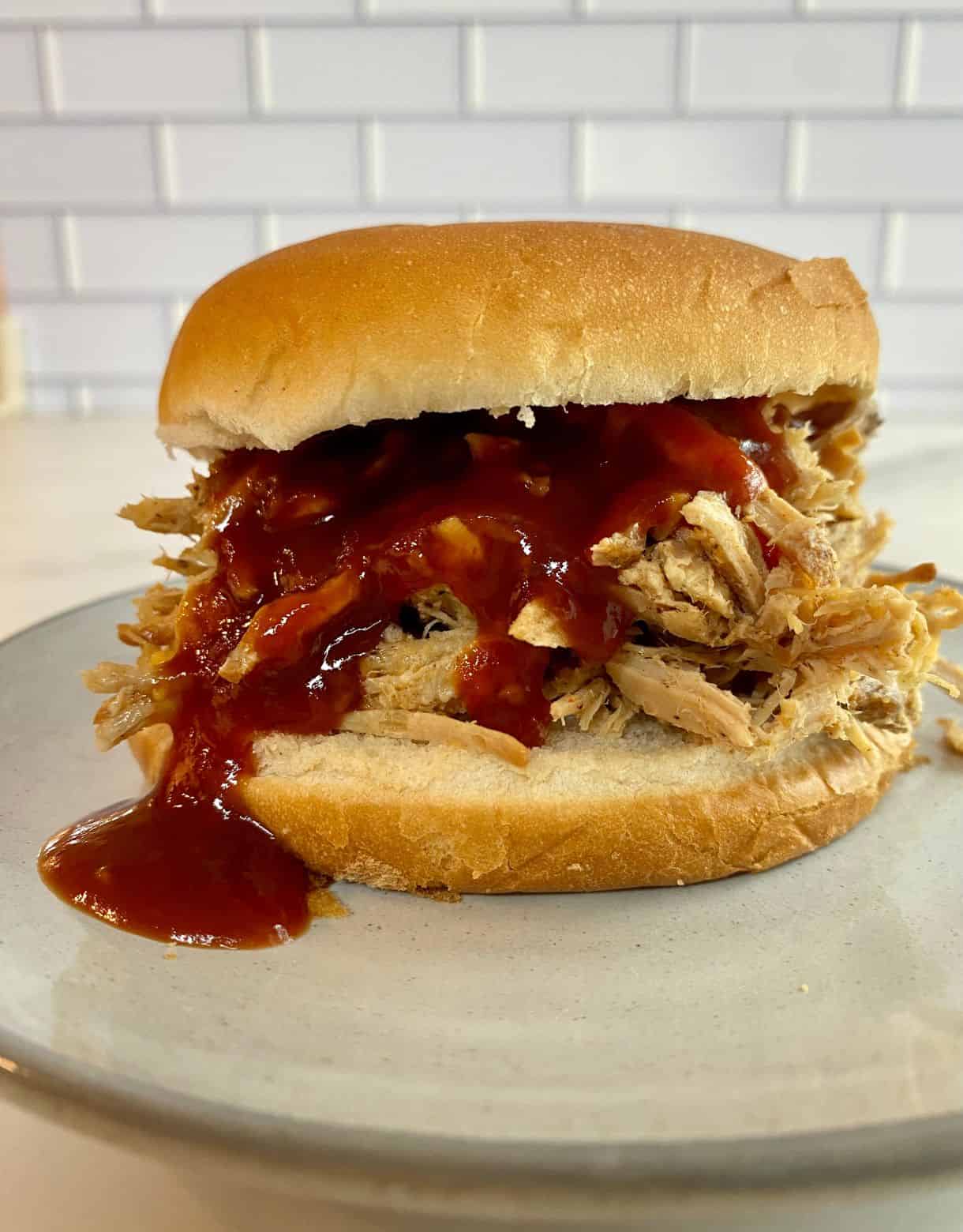 Coca-Cola Pulled Pork on a bun with BBQ sauce.