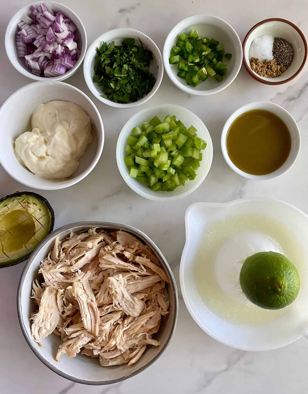 Ingredients for Guacamole Chicken Salad. Shredded chicken, avocado, lime juice, diced celery, diced red onion, chopped cilantro, chopped jalapeno, jalapeno hot sauce, mayonnaise, salt, pepper and cumin.