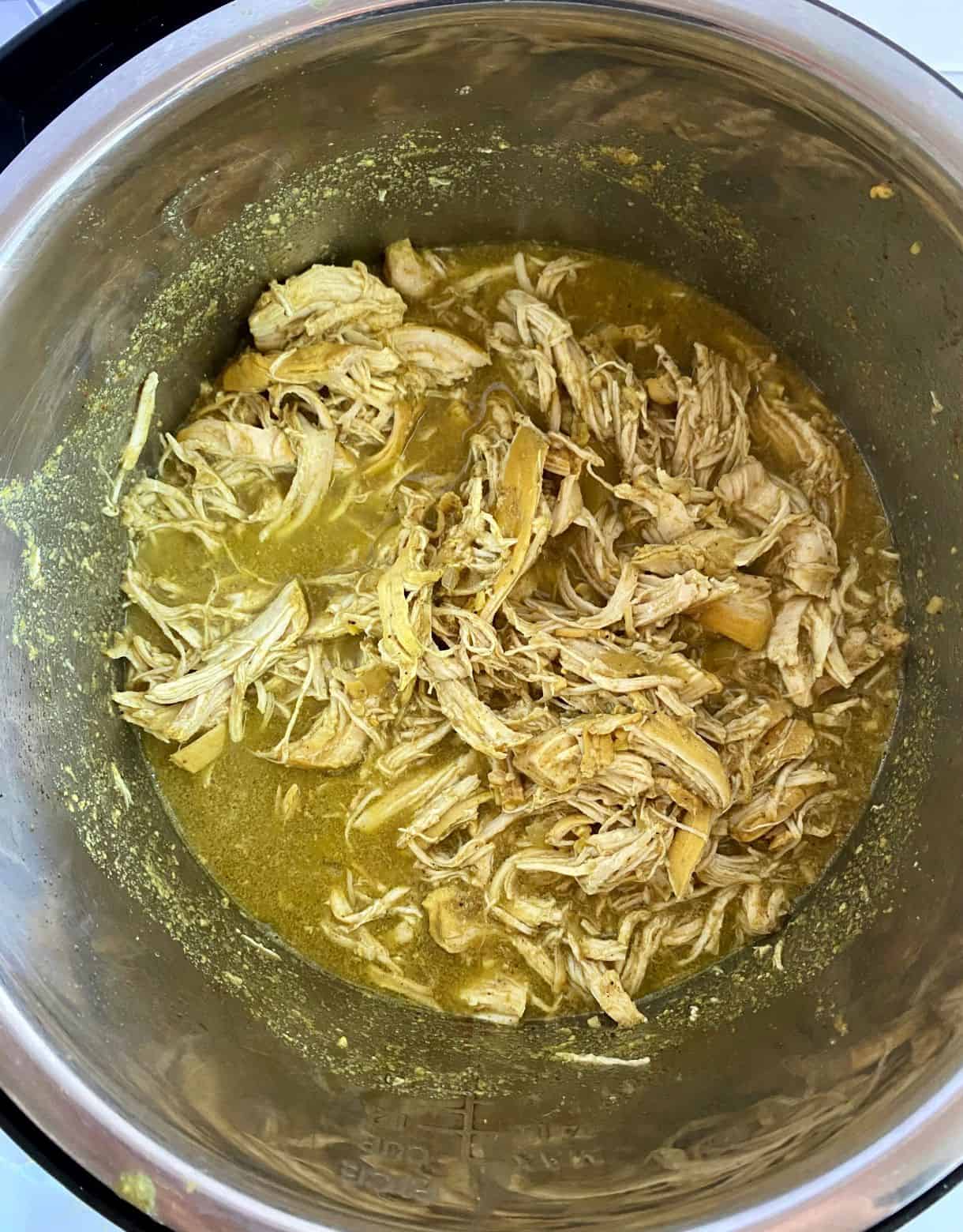 A slow cooker with cooked curry chicken.