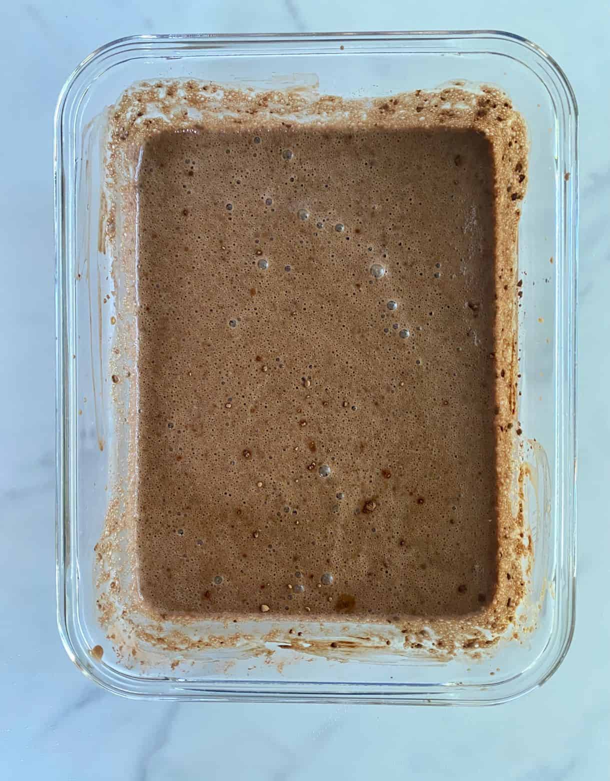 A dish with mixed Chocolate Peanut Butter Chia Pudding ready to refrigerate.