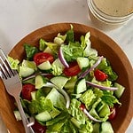 A House Salad with a jar of Red Wine Vinaigrette.