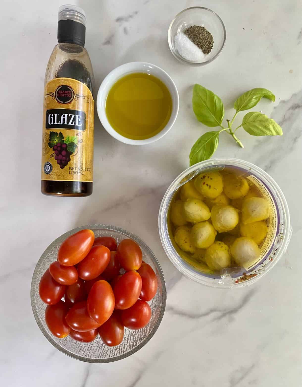 Grape tomatoes, bocconcini, olive oil, salt, pepper and balsamic glaze.