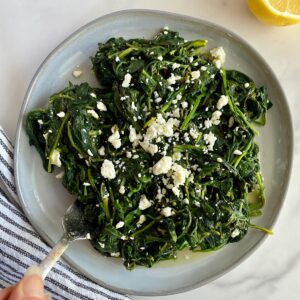 A plate of cooked spinach and feta.