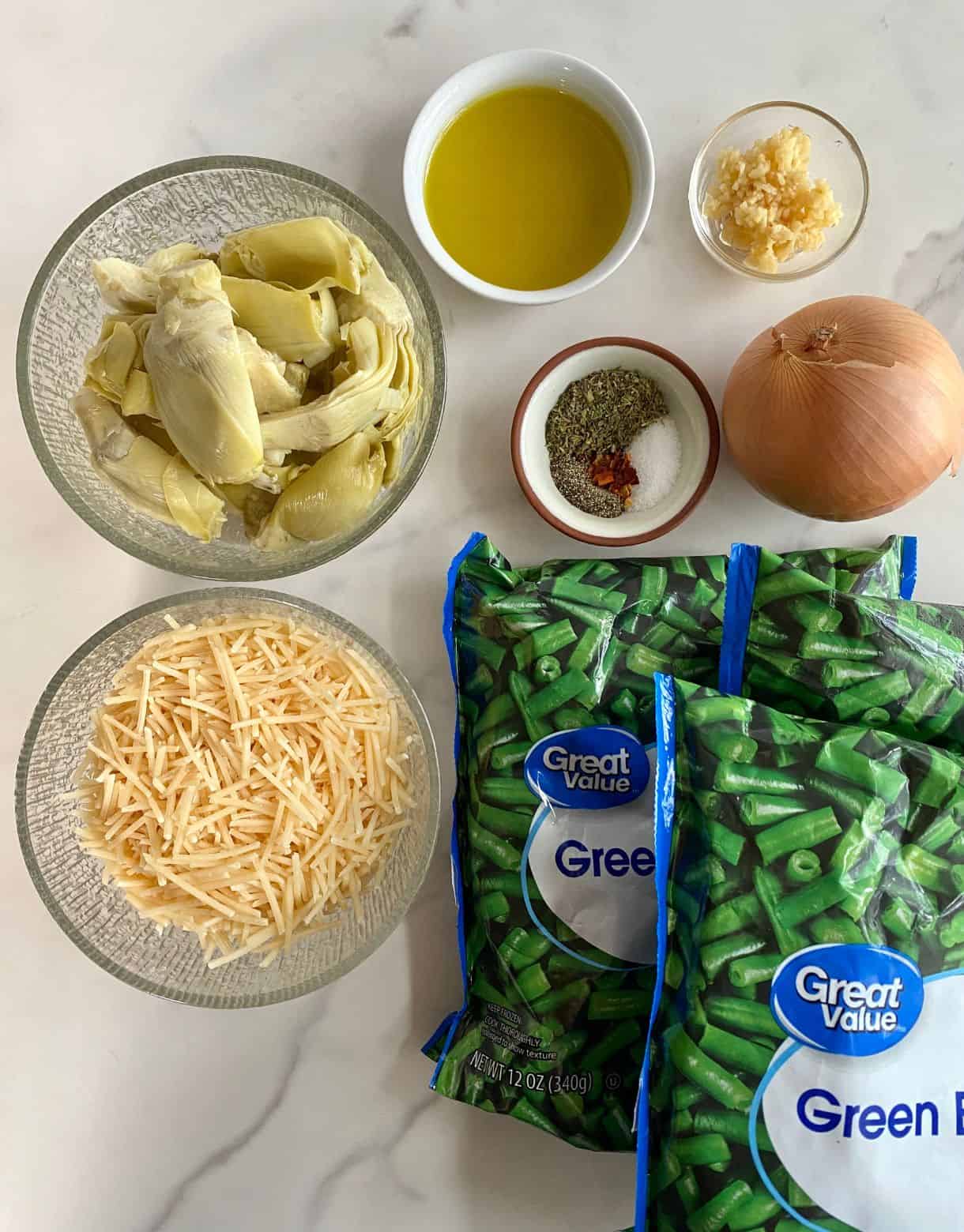 3 bags of frozen green beans, shredded parmesan cheese, artichoke hearts, olive oil, an onion, minced garlic, salt, pepper, red pepper flakes and Italian seasoning.